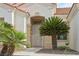 Close up of front entryway with front door, security gate and desert landscaping at 10513 Longwood Dr, Las Vegas, NV 89134