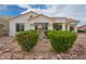 Front of house featuring desert landscaping, fountain, bushes, and neutral colors at 10513 Longwood Dr, Las Vegas, NV 89134