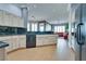 Open floor plan shows the gourmet kitchen with wood-style floors, custom cabinets and black countertops at 10513 Longwood Dr, Las Vegas, NV 89134