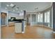 Gourmet kitchen features custom cabinets, black countertops, black appliances and wood-style floors at 10513 Longwood Dr, Las Vegas, NV 89134