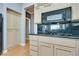 This kitchen contains wood cabinets, black countertops, and stainless steel appliances at 10513 Longwood Dr, Las Vegas, NV 89134