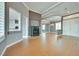 Open-concept living area featuring a fireplace and wood-look tile flooring at 10513 Longwood Dr, Las Vegas, NV 89134