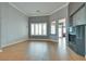 Spacious living room with wood-style tile floor, fireplace and plenty of natural light from a large window at 10513 Longwood Dr, Las Vegas, NV 89134