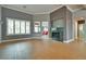Bright living room features wood-look tile flooring, white trim and a fireplace at 10513 Longwood Dr, Las Vegas, NV 89134