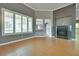 Bright living room features wood-look tile flooring, white trim and a fireplace at 10513 Longwood Dr, Las Vegas, NV 89134