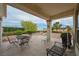 Covered outdoor patio area with table, chairs, and views of the backyard and landscape at 10513 Longwood Dr, Las Vegas, NV 89134