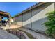 Backyard with stone walkway, water feature, patio cover, and mature landscaping at 1060 Neil Armstrong Cir, Las Vegas, NV 89145