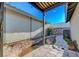 Backyard with stone walkway, stream feature, desert landscaping, and wood patio cover at 1060 Neil Armstrong Cir, Las Vegas, NV 89145