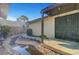 Charming backyard with rock stream, covered patio, desert landscaping, and privacy at 1060 Neil Armstrong Cir, Las Vegas, NV 89145