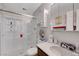 Bright bathroom with a shower and tub, a vanity, and tiled walls at 1060 Neil Armstrong Cir, Las Vegas, NV 89145