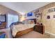 Cozy bedroom with wood-look flooring, natural light, and traditional decor at 1060 Neil Armstrong Cir, Las Vegas, NV 89145