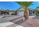 Inviting home exterior with a large palm tree, well-maintained landscaping, and a spacious driveway at 1060 Neil Armstrong Cir, Las Vegas, NV 89145