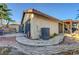 Exterior view of home features stone patio, water feature, and covered outdoor kitchen at 1060 Neil Armstrong Cir, Las Vegas, NV 89145