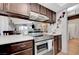 Traditional kitchen with stainless steel range, tile flooring, and open view to the living area at 1060 Neil Armstrong Cir, Las Vegas, NV 89145