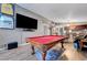 Bright living room with a pool table, large TV, and open access to other living areas at 1060 Neil Armstrong Cir, Las Vegas, NV 89145