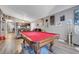 Open-concept living room featuring a pool table, comfortable seating, and access to the kitchen at 1060 Neil Armstrong Cir, Las Vegas, NV 89145