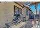 Covered outdoor kitchen features a built-in grill and fire pit table for entertaining at 1060 Neil Armstrong Cir, Las Vegas, NV 89145