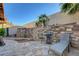 Relaxing patio with stone floor, lounge chair, table, and landscaped stone wall feature at 1060 Neil Armstrong Cir, Las Vegas, NV 89145