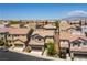 A residential neighborhood with tan colored homes with tile roofs on a sunny day at 10750 Red Badge Ave, Las Vegas, NV 89166