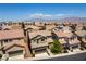 A residential neighborhood with tan colored homes with tile roofs on a sunny day at 10750 Red Badge Ave, Las Vegas, NV 89166