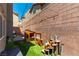 A fenced back yard with a playhouse and artificial turf and patio at 10750 Red Badge Ave, Las Vegas, NV 89166