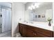 Bathroom with double vanity sink, dark wood cabinets and a mirror at 10750 Red Badge Ave, Las Vegas, NV 89166