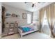 Cozy bedroom with natural light, decorative tree, and a comfortable single bed at 10750 Red Badge Ave, Las Vegas, NV 89166