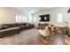 Comfortable living room with a sectional sofa, neutral tones, and shuttered windows at 10750 Red Badge Ave, Las Vegas, NV 89166