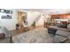 Open-concept living room showcasing wood-look flooring, stairs, and seamless flow to other spaces at 10750 Red Badge Ave, Las Vegas, NV 89166