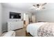 Large main bedroom featuring a dresser, TV and view of the bathroom at 10750 Red Badge Ave, Las Vegas, NV 89166