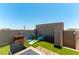 An outdoor patio features artificial turf, a tile patio and an assortment of items including games and seating at 10750 Red Badge Ave, Las Vegas, NV 89166