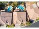 Aerial view showcases the home, swimming pool, lush backyard, and surrounding neighborhood at 11112 Pine Greens Ct, Las Vegas, NV 89144