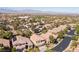 Expansive aerial view of a residential neighborhood with mature trees and mountain views in the distance at 11112 Pine Greens Ct, Las Vegas, NV 89144