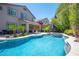 Lush backyard oasis featuring a pool, spa, and mature landscaping at 11112 Pine Greens Ct, Las Vegas, NV 89144