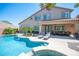 Captivating backyard featuring a swimming pool, outdoor seating, and landscaped garden at 11112 Pine Greens Ct, Las Vegas, NV 89144