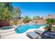 Private backyard with a refreshing pool, spa, and tropical landscaping at 11112 Pine Greens Ct, Las Vegas, NV 89144