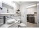 Well-lit bathroom with modern fixtures and adjacent laundry room at 11112 Pine Greens Ct, Las Vegas, NV 89144