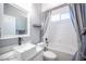 Bright bathroom featuring a sink, bathtub, and a grey shower curtain at 11112 Pine Greens Ct, Las Vegas, NV 89144