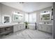 Modern bathroom boasting marble floors, dual vanities, and a freestanding tub at 11112 Pine Greens Ct, Las Vegas, NV 89144