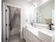 Bright bathroom featuring double sinks with a large mirror, and a shower tub combination at 11112 Pine Greens Ct, Las Vegas, NV 89144