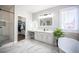 Bathroom featuring dual vanities, a freestanding tub, and a shower at 11112 Pine Greens Ct, Las Vegas, NV 89144