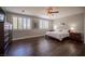 Spacious bedroom featuring hardwood floors, a ceiling fan, and shuttered windows at 11112 Pine Greens Ct, Las Vegas, NV 89144