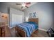 Spacious bedroom featuring a ceiling fan, a wooden bed frame, and a large closet with natural light at 11112 Pine Greens Ct, Las Vegas, NV 89144