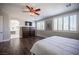 Bedroom featuring hardwood floors, a ceiling fan, and an ensuite bathroom at 11112 Pine Greens Ct, Las Vegas, NV 89144