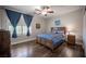 Bright bedroom with hardwood floors, a ceiling fan, and a window, offering a peaceful retreat at 11112 Pine Greens Ct, Las Vegas, NV 89144