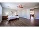 Bedroom featuring hardwood floors, a ceiling fan, and an ensuite room at 11112 Pine Greens Ct, Las Vegas, NV 89144