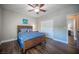 Cozy bedroom with hardwood floors, a ceiling fan, and natural light, creates a relaxing atmosphere at 11112 Pine Greens Ct, Las Vegas, NV 89144