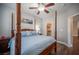 Bedroom with a four poster bed, modern ceiling fan, dark wood floors and door to walk-in closet at 11112 Pine Greens Ct, Las Vegas, NV 89144