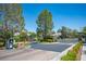 Elegant community entrance featuring wrought iron gates and meticulously landscaped surroundings at 11112 Pine Greens Ct, Las Vegas, NV 89144