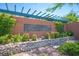 A welcoming 'Woodlands' community sign surrounded by vibrant greenery and a decorative stone border at 11112 Pine Greens Ct, Las Vegas, NV 89144